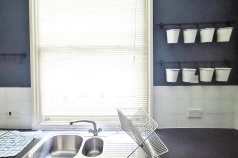 Bright and tidy kitchen featuring a dual stainl...
