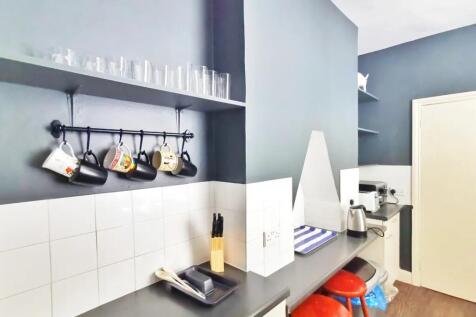 Compact and tidy kitchen area featuring a sleek...