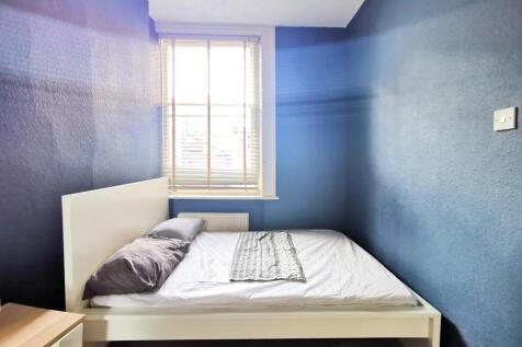 A cozy double bedroom featuring a clean white b...
