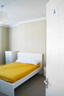 Bright and tidy double bedroom featuring a cris...