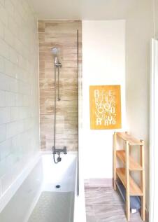 Bright and modern bathroom suite featuring a sl...