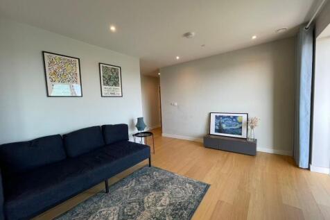 Bright, modern living area with wood flooring, ...