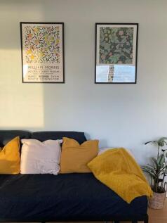 Bright, stylish living area with a dark sofa dr...