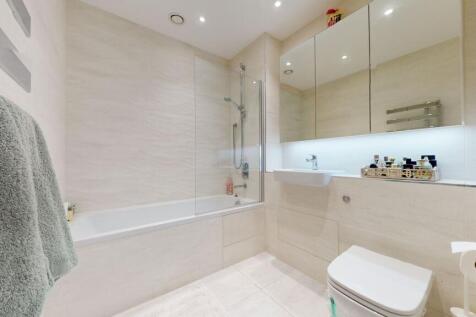Bright, modern bathroom with a combined bath an...