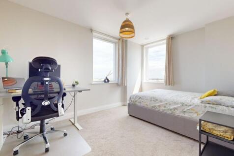 Bright, modern double bedroom with a comfortabl...