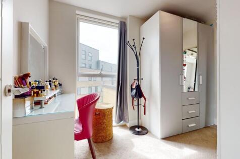 Bright, modern bedroom corner with a vanity by ...
