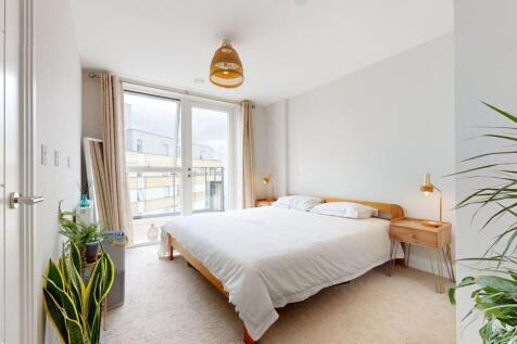 Bright, modern master bedroom with a large doub...