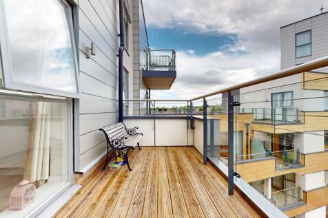 Bright modern balcony with timber decking, glas...