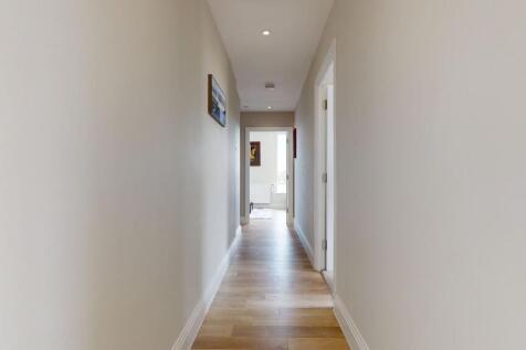 Bright, well-maintained hallway with wood-effec...