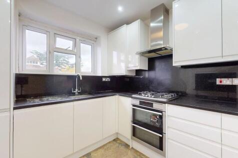 Modern fitted kitchen with glossy white cabinet...