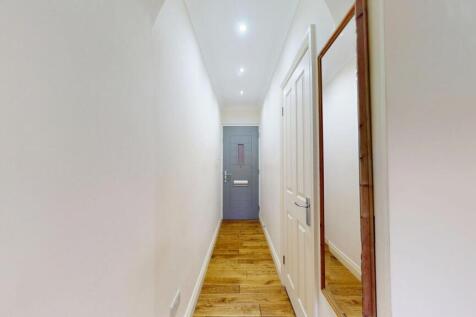 Bright, well-maintained hallway with wooden flo...