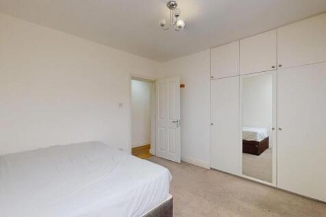 Bright, neutrally decorated double bedroom with...