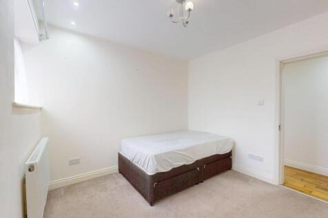 Neat, neutrally decorated bedroom with a simple...