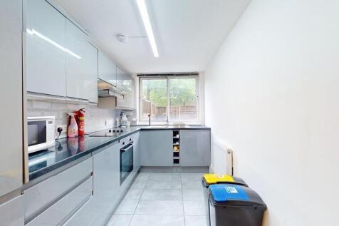 Modern galley kitchen with glossy grey cabinets...