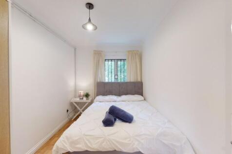 Bright, neatly presented bedroom with a comfort...