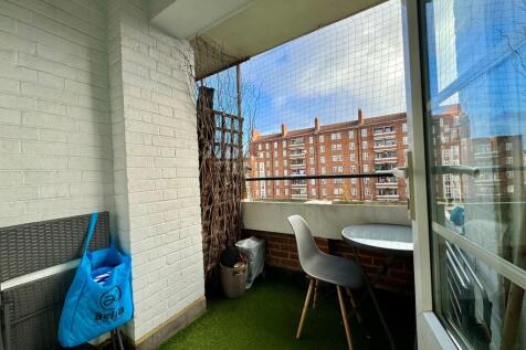 Covered balcony with artificial turf, a small b...