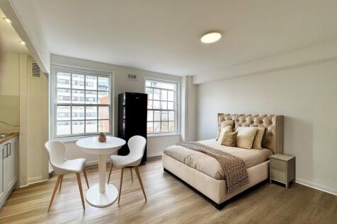 Bright, modern double bedroom with a plush upho...