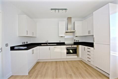 Bright modern kitchen with white high-gloss cab...