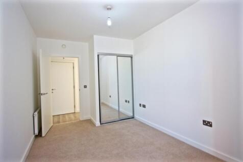 Bright, neutral bedroom with fitted mirrored sl...