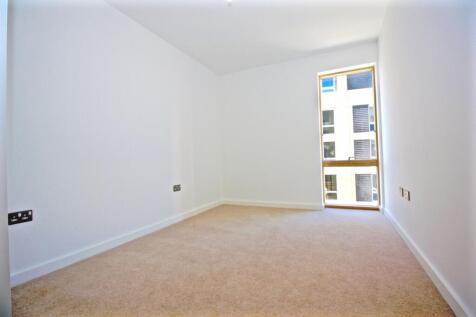 Bright, freshly painted bedroom with neutral ca...
