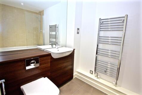 Bright, modern bathroom with a sleek white basi...