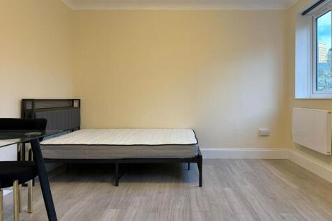 Bright, freshly painted bedroom with contempora...