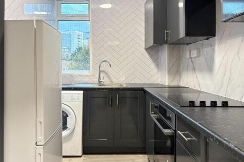 Modern fitted kitchen with sleek black cabinets...