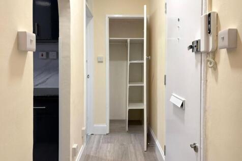 Bright, freshly painted hallway with wood-effec...