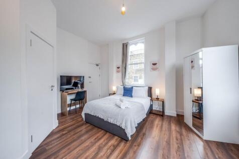 Bright and spacious master bedroom featuring a ...