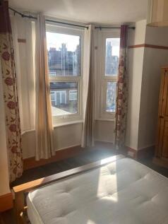 A bright double bedroom featuring large bay win...