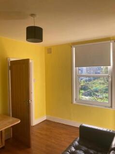 A bright living room with cheerful yellow walls...