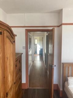 A clean and well-maintained hallway featuring w...