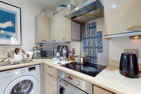 Compact and well-equipped kitchen featuring mod...