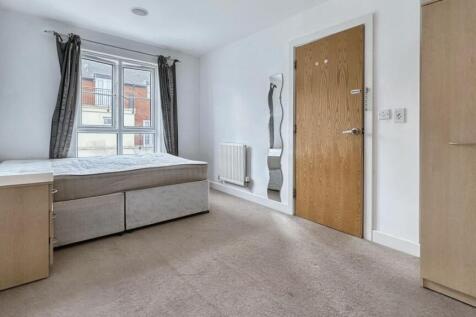 A clean and well-lit double bedroom featuring a...