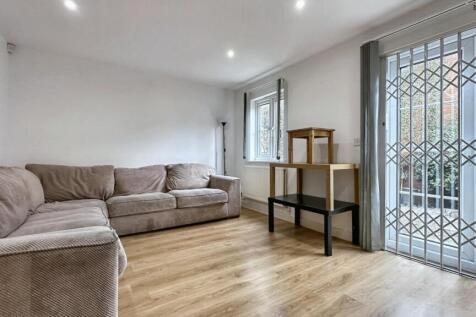 A clean and bright living room with a cozy sofa...