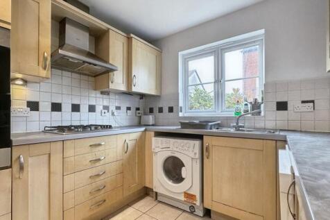 A clean and well-lit kitchen with modern applia...