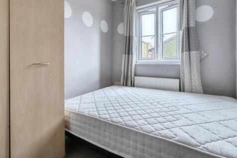 A tidy double bedroom with a light color scheme...