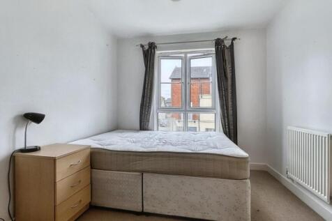 A tidy double bedroom featuring a bed, bedside ...