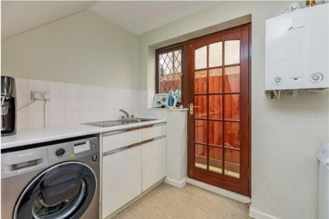 A tidy kitchen with a washing machine and natur...