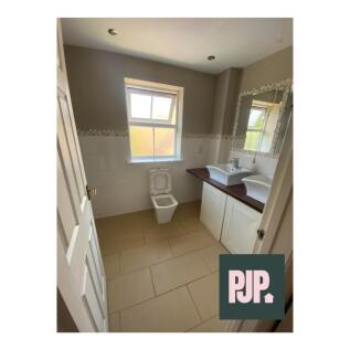 A spacious and well-lit bathroom featuring mode...