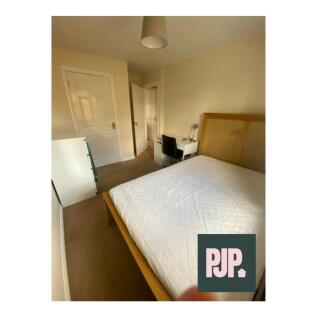A well-lit and tidy double bedroom featuring a ...
