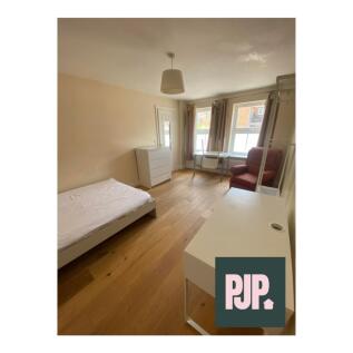 A bright and spacious double bedroom with large...