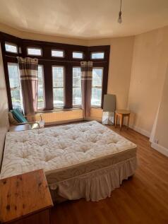 A spacious and well-lit double bedroom featurin...