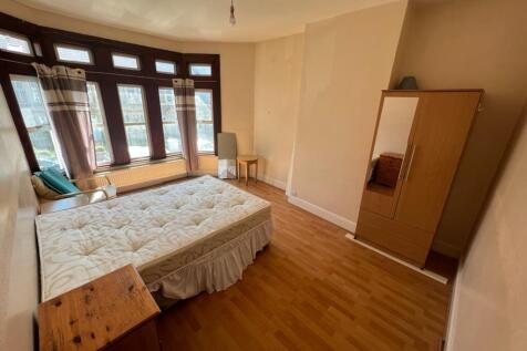 A spacious and bright double bedroom featuring ...