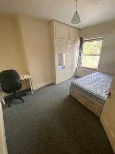 A bright and spacious double bedroom with a fit...