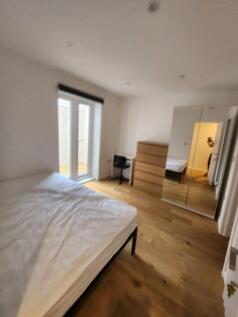 Bright double bedroom featuring large windowed ...