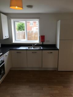 A bright and tidy kitchenette with modern fixtu...