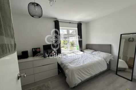 A bright and inviting double bedroom featuring ...