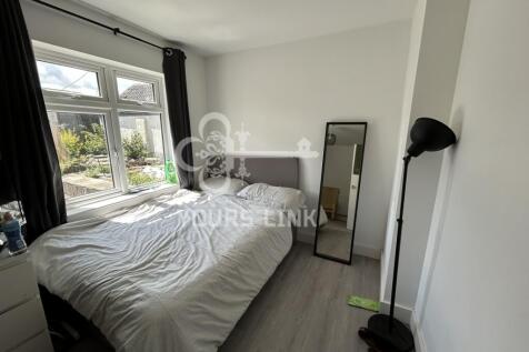 A bright and spacious double bedroom with moder...