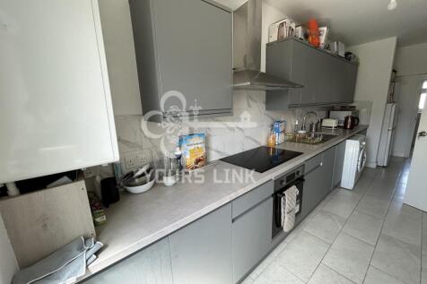 A modern kitchen with ample storage and natural...